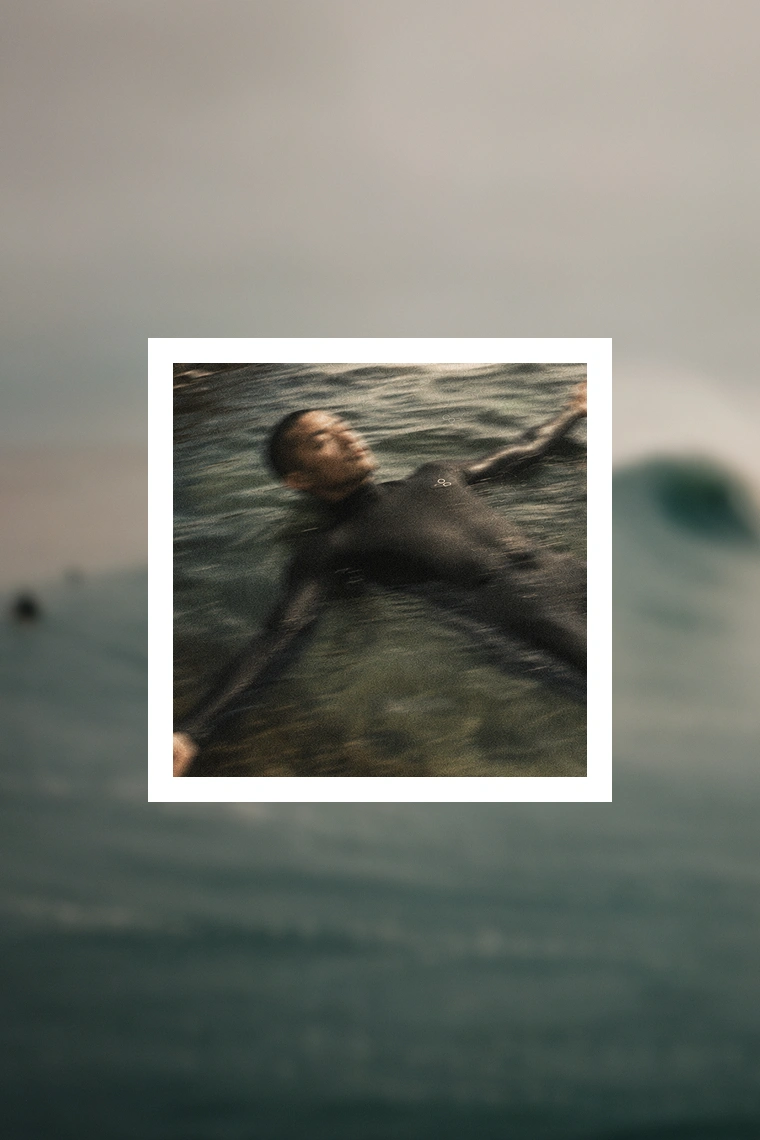 Surfer floating, suit under load